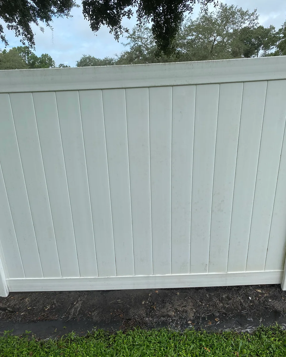 The same fence panel after cleaning, with the lower-edge buildup no longer visible.