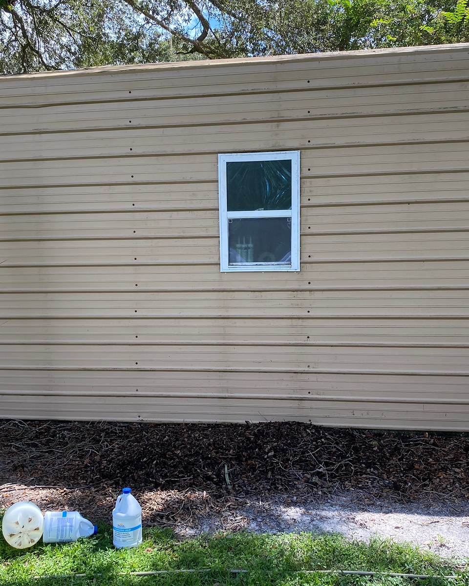 The same wall after a house wash, with the visible green algae no longer present.